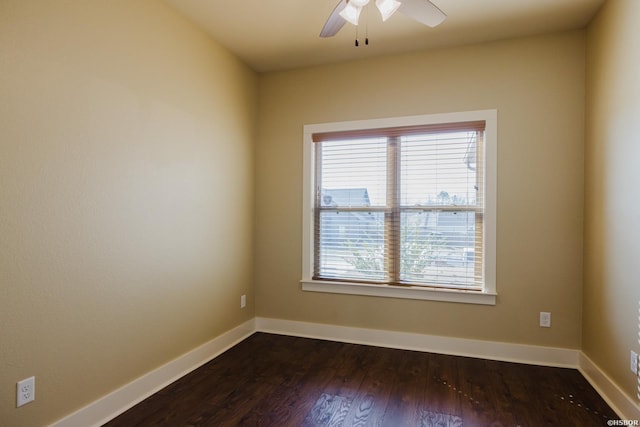 empty room with ceiling fan, baseboards, and dark wood-style flooring