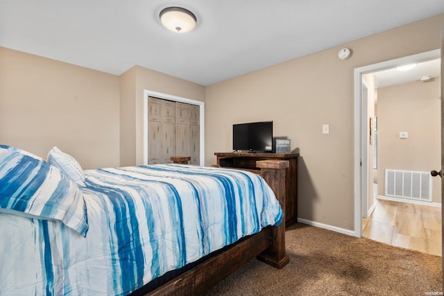bedroom featuring visible vents, baseboards, a closet, and light carpet