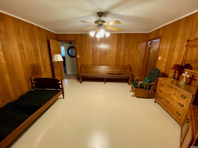 living area featuring wood walls, carpet, and crown molding