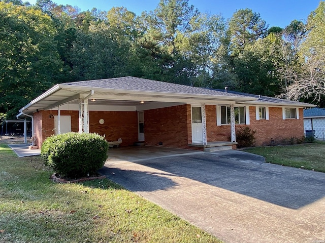 ranch-style home featuring driveway, crawl space, a front lawn, a carport, and brick siding