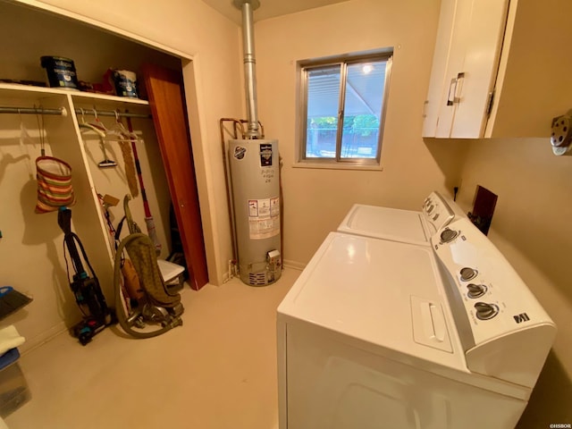 washroom featuring gas water heater, cabinet space, and washing machine and clothes dryer