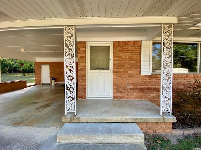 entrance to property featuring brick siding