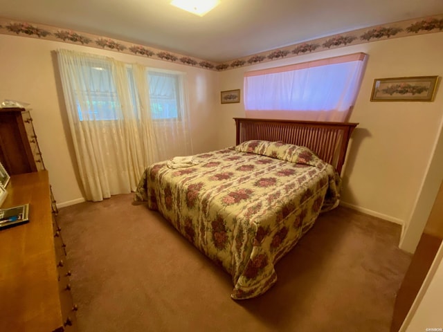 bedroom featuring carpet floors and baseboards