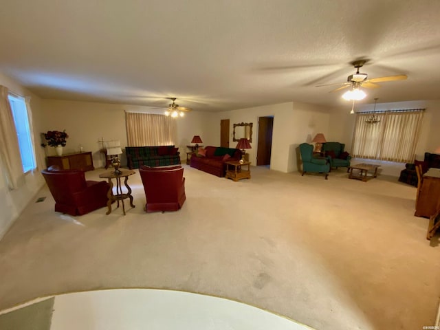 carpeted living room featuring a ceiling fan