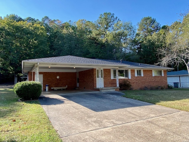 ranch-style house featuring brick siding, concrete driveway, crawl space, a carport, and a front yard