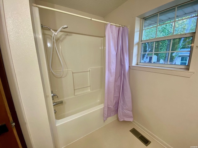 full bathroom featuring baseboards, visible vents, shower / bath combo with shower curtain, and a textured ceiling