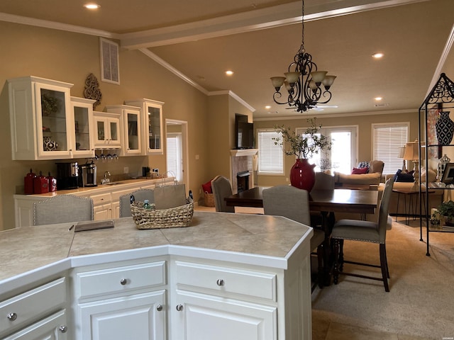 141 Central Ter Unit D, Hot Springs, AR 71913 - kitchen with a fireplace, visible vents, hanging light fixtures, glass insert cabinets, and white cabinets