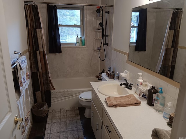 full bath with vanity, tile walls, toilet, and shower / bath combo with shower curtain