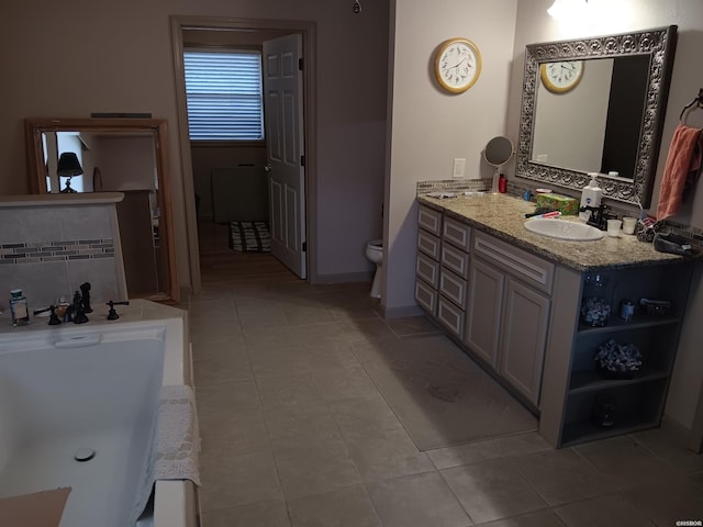 bathroom with tasteful backsplash, baseboards, toilet, tile patterned flooring, and vanity