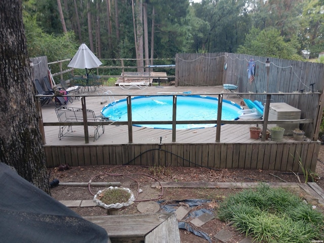 view of swimming pool with fence, a deck, and a fenced in pool