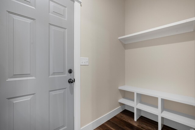 mudroom with dark wood-style floors and baseboards