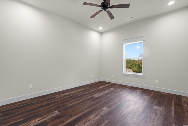 spare room with baseboards, visible vents, dark wood-style flooring, and recessed lighting