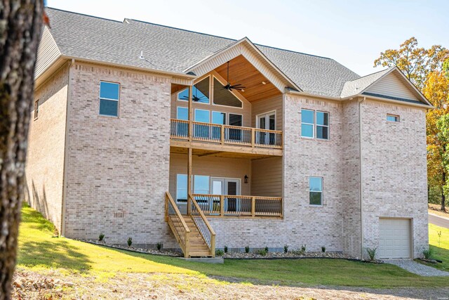 back of house with ceiling fan, a balcony, brick siding, a yard, and roof with shingles