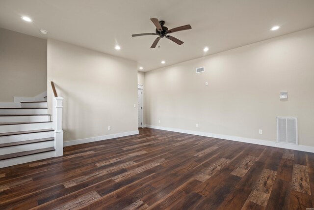 empty room with stairs, visible vents, dark wood finished floors, and recessed lighting