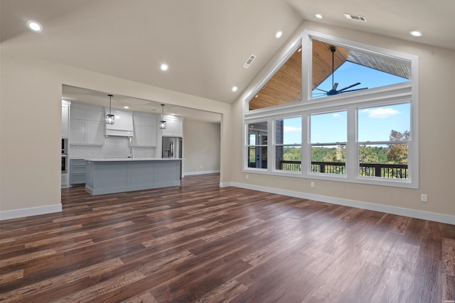 unfurnished living room featuring dark wood-style floors, visible vents, and baseboards