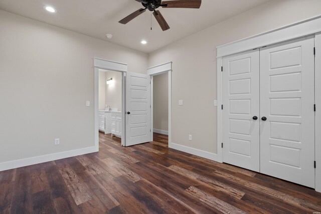 unfurnished bedroom featuring baseboards, dark wood finished floors, a closet, and recessed lighting