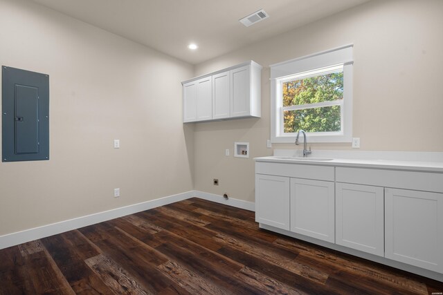 laundry area featuring electric panel, baseboards, visible vents, washer hookup, and a sink