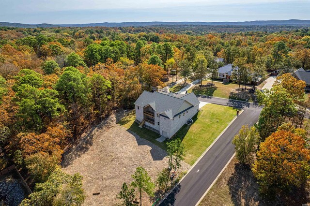 drone / aerial view featuring a view of trees