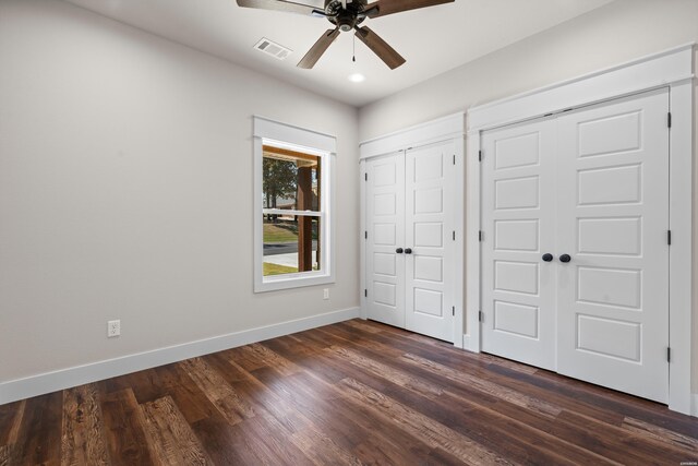 unfurnished bedroom with recessed lighting, visible vents, multiple closets, baseboards, and dark wood-style floors