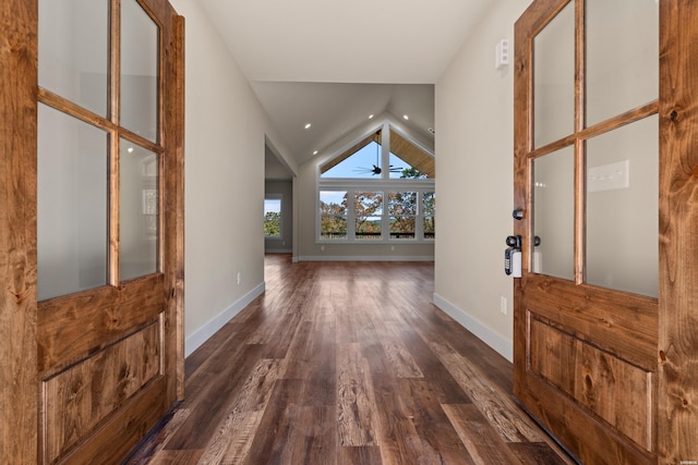 entrance foyer with dark wood-style floors, lofted ceiling, baseboards, and recessed lighting