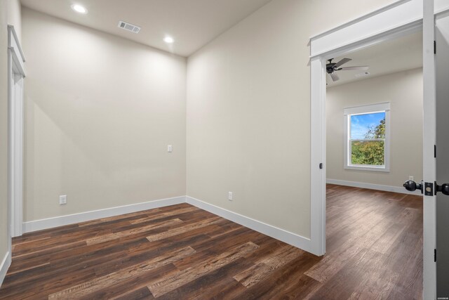 spare room featuring baseboards, visible vents, ceiling fan, dark wood-style flooring, and recessed lighting