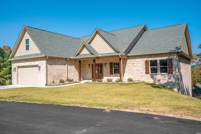 view of front of home with a garage, a front lawn, concrete driveway, and roof with shingles