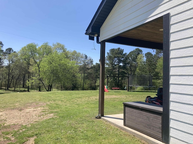 197 Country View Trl, Pearcy, AR 71964 - view of green lawn with a trampoline and view of wooded area