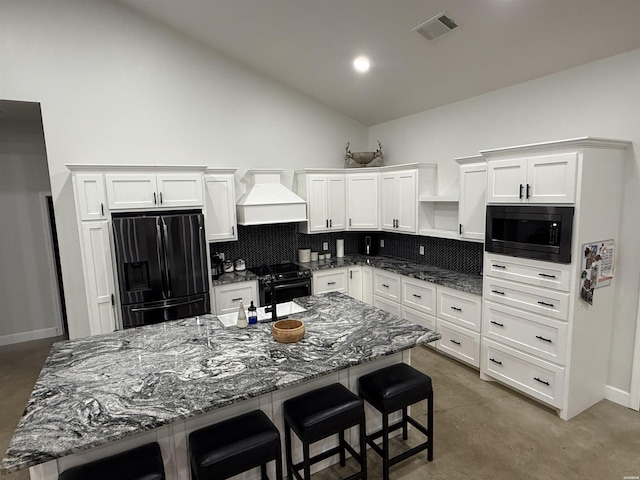 197 Country View Trl, Pearcy, AR 71964 - kitchen featuring black appliances, premium range hood, white cabinetry, a kitchen breakfast bar, and high vaulted ceiling