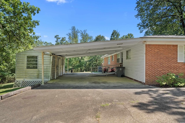 view of car parking with aphalt driveway and a carport