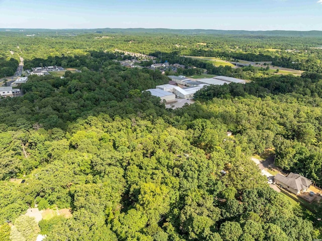 drone / aerial view featuring a view of trees