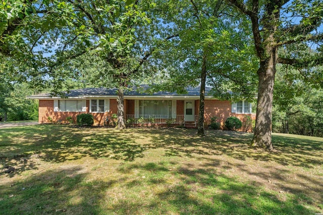 ranch-style home with a front lawn and brick siding