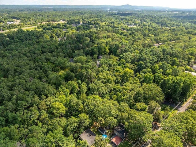 drone / aerial view featuring a wooded view