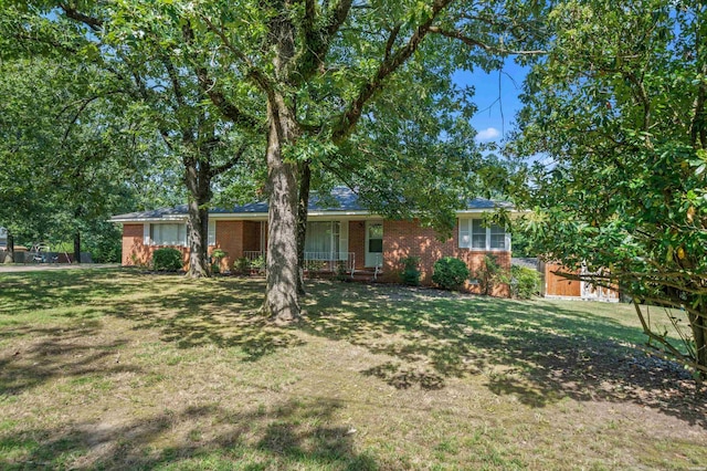 ranch-style home with fence, a front lawn, and brick siding