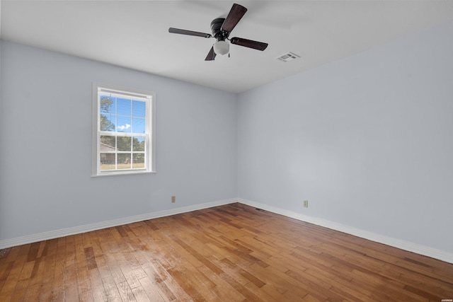 spare room with visible vents, baseboards, light wood-style flooring, and a ceiling fan