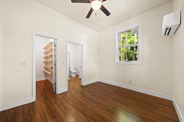 301 Walter St, Hot Springs, AR 71901 - unfurnished bedroom with a wall mounted air conditioner, a walk in closet, dark wood finished floors, and baseboards