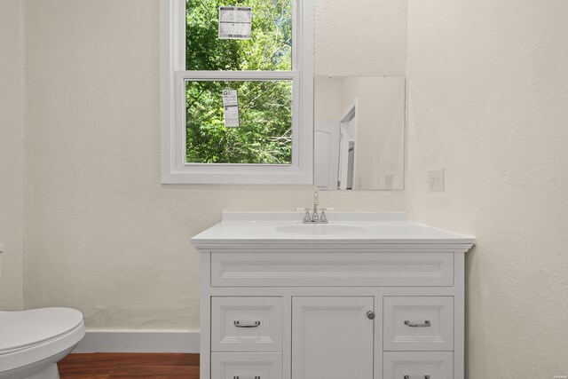 301 Walter St, Hot Springs, AR 71901 - half bathroom featuring wood finished floors, vanity, toilet, and baseboards