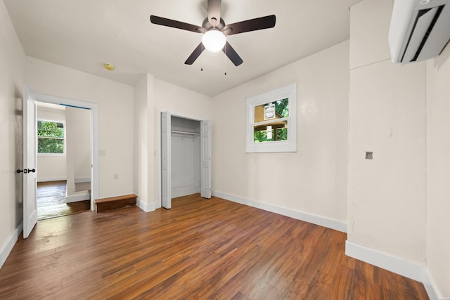 301 Walter St, Hot Springs, AR 71901 - unfurnished bedroom with wood finished floors, baseboards, a closet, and a wall mounted AC