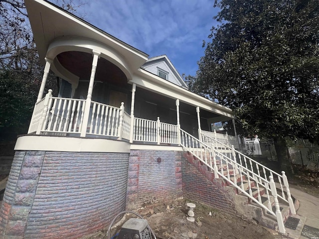 view of front of property featuring a porch and stairs