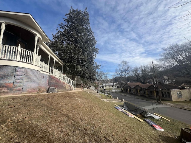 view of yard featuring stairway and a residential view