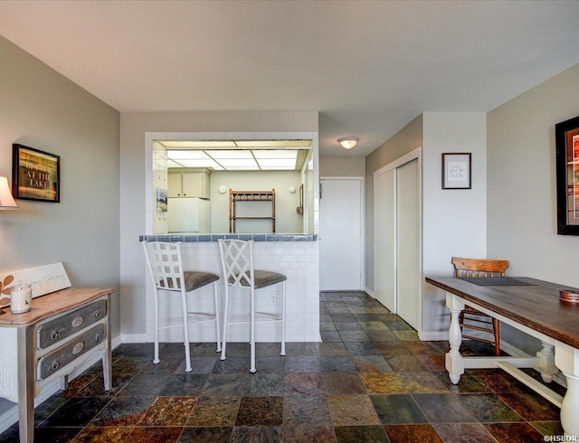 740 Weston Rd Unit B-804, Hot Springs, AR 71913 - kitchen featuring baseboards, a breakfast bar area, and stone tile flooring