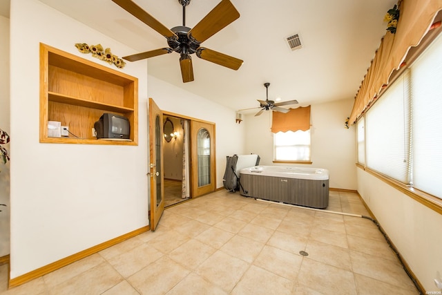 bedroom featuring light tile patterned floors, baseboards, visible vents, and ceiling fan