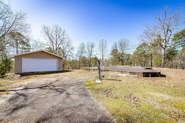 exterior space with a detached garage and an outdoor structure