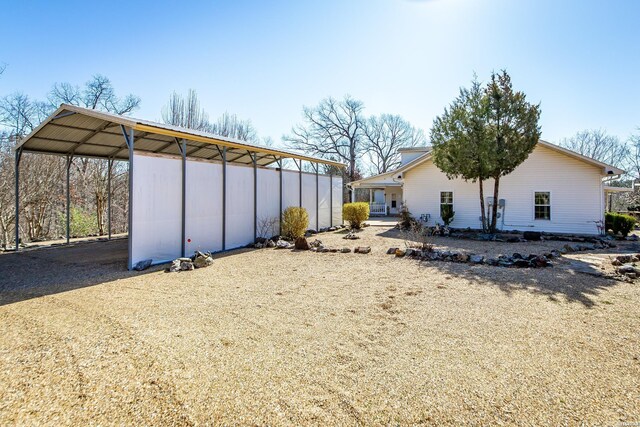 view of yard with a carport and driveway