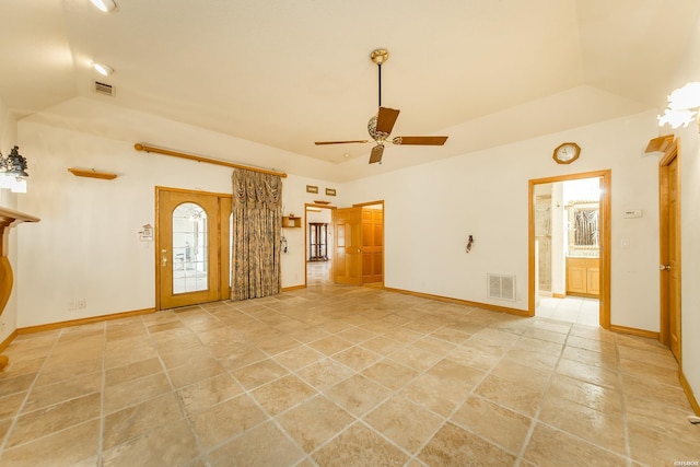 unfurnished living room with visible vents, a raised ceiling, and baseboards