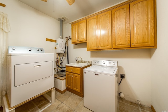 washroom featuring a sink, cabinet space, a ceiling fan, and washer and dryer