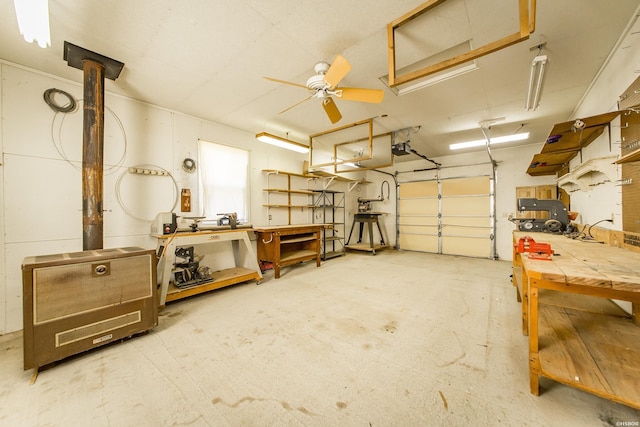 garage featuring a ceiling fan, a workshop area, and a garage door opener