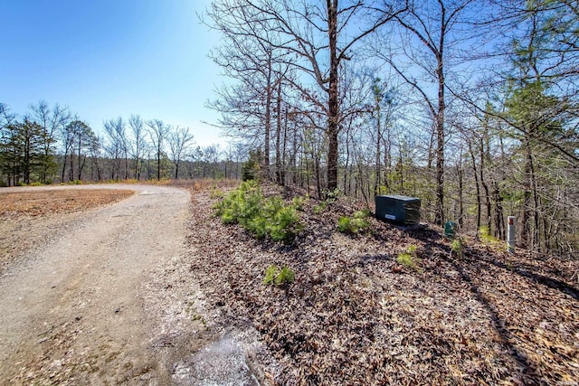 view of road featuring a wooded view