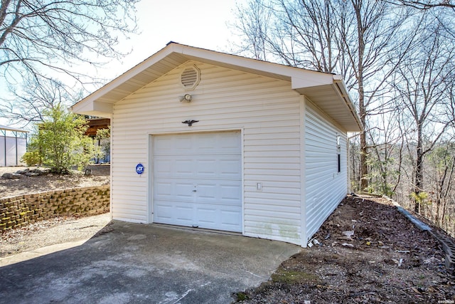 detached garage featuring driveway