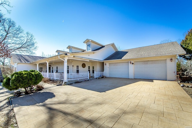 view of front of home with an attached garage, covered porch, and driveway