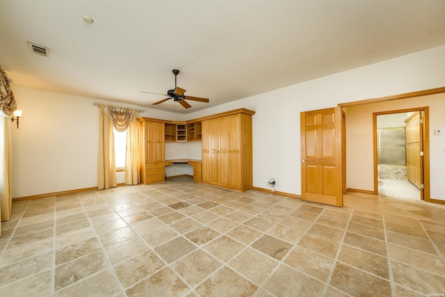 unfurnished living room with baseboards, a ceiling fan, visible vents, and built in study area